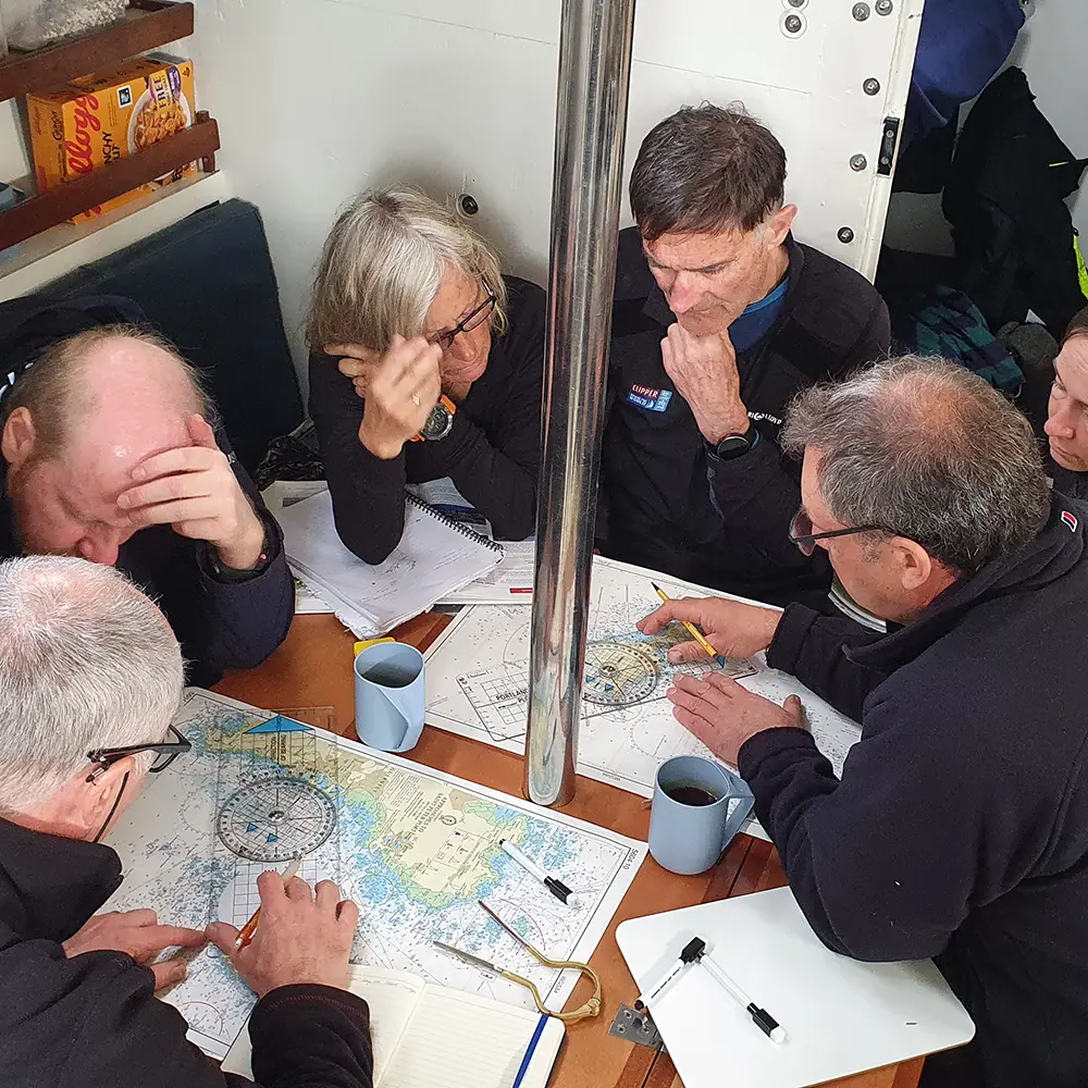 Crew navigating on a chart