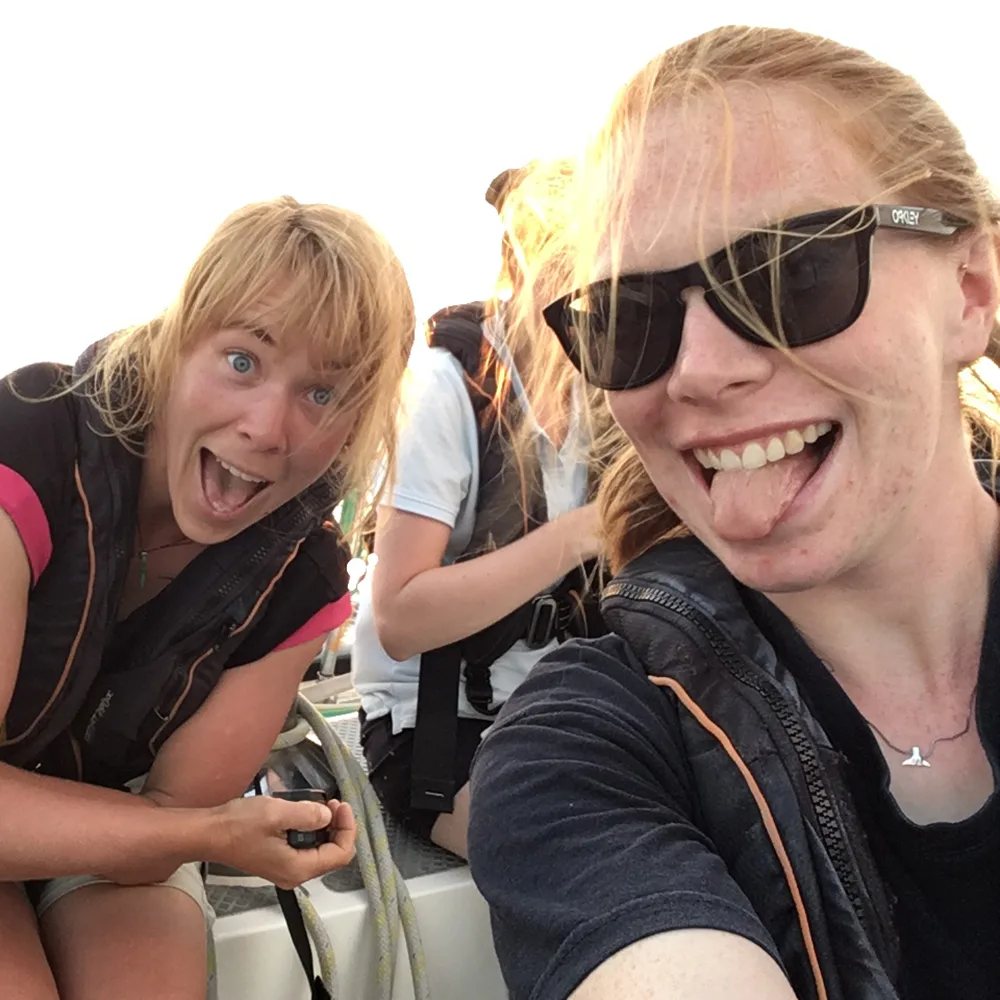 two girls having fun on a sailboat