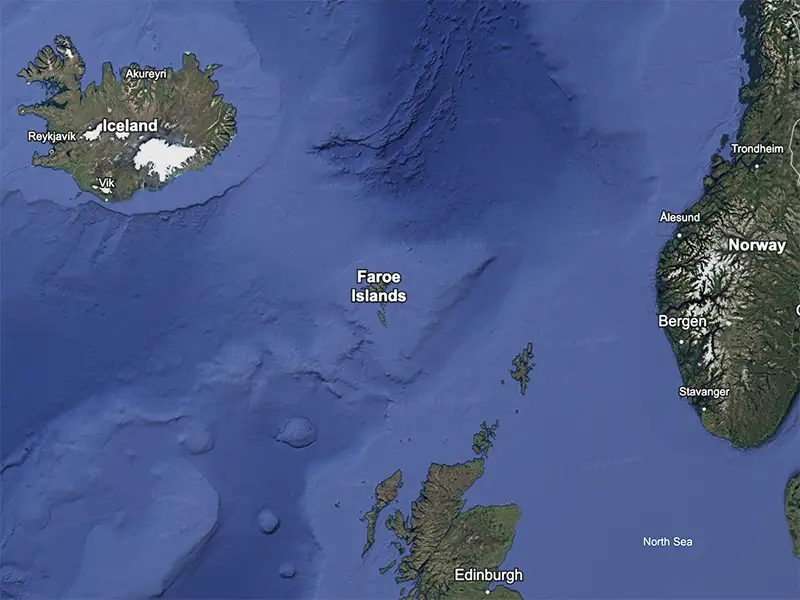 A satellite map showing the Faroe Islands in the North Atlantic Ocean, positioned between Iceland, Norway, and Scotland. The map highlights major locations, including Reykjavik in Iceland, Bergen in Norway, and Edinburgh in Scotland, illustrating the remote yet strategic location of the archipelago.